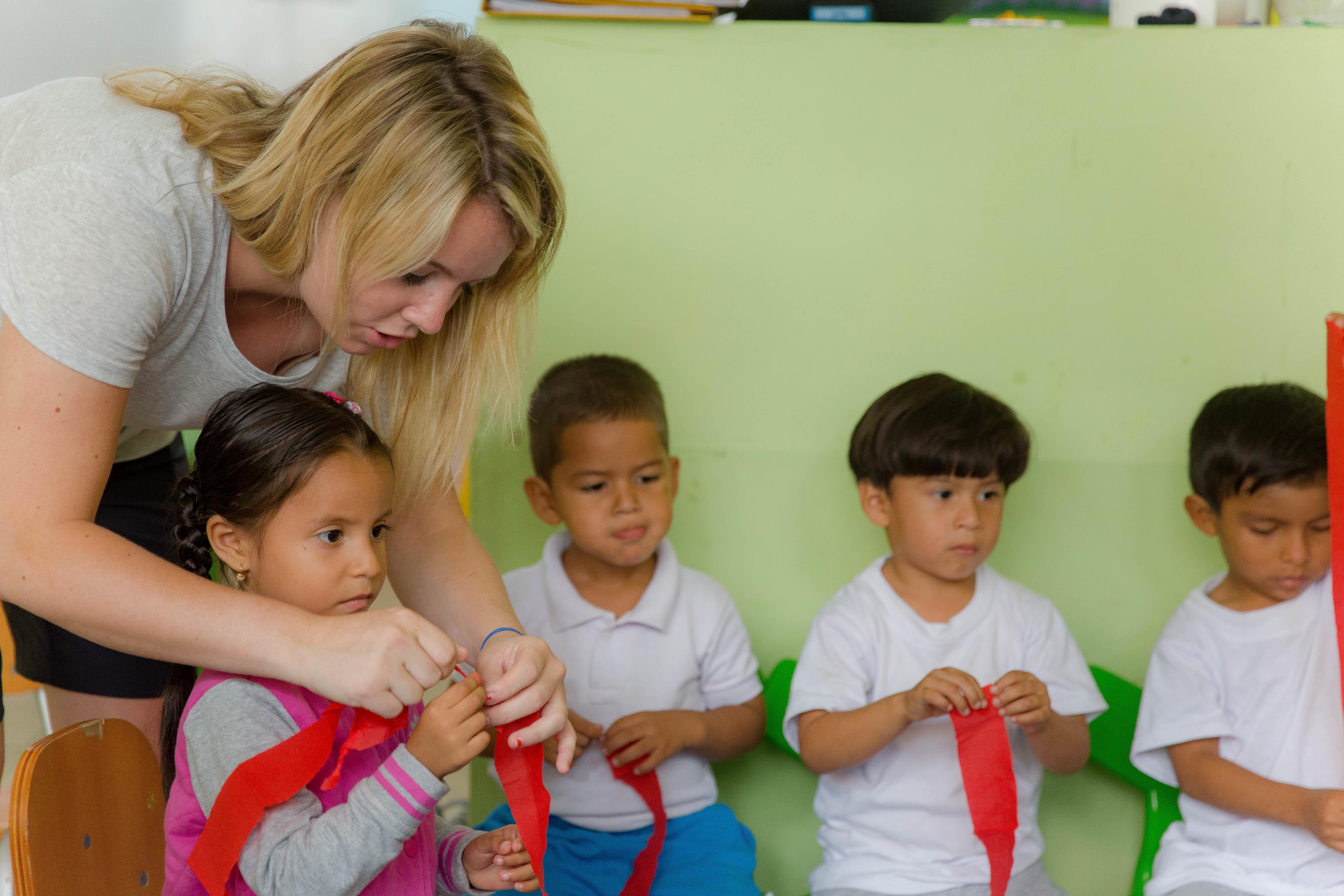 A Projects Abroad Social Work intern in Ecuador works through an activity with children An intern works with a group of children during her Social Work internship in Ecuador